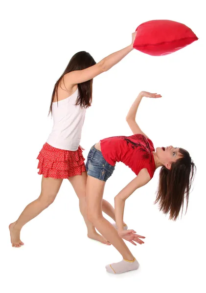Two girls fighting on the pillows — Stock Photo, Image