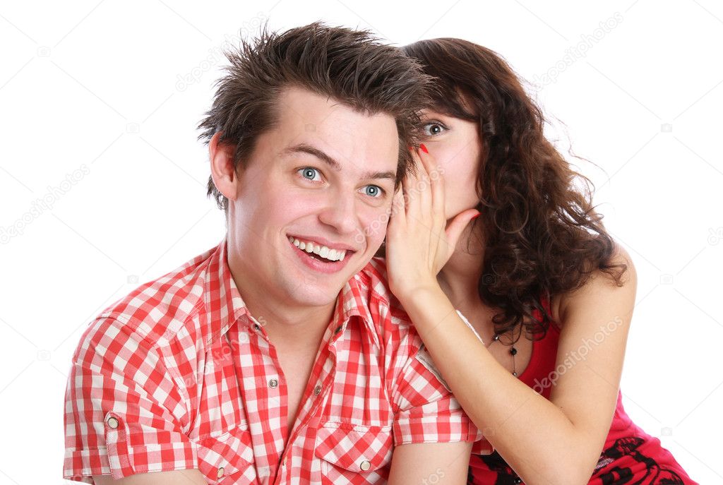 A girl whispers in the guy's ear