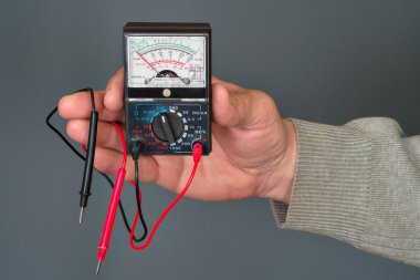 Multimeter in a hand clipart