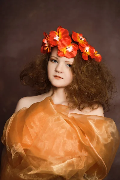 Chica adolescente en una corona de flores rojas — Foto de Stock