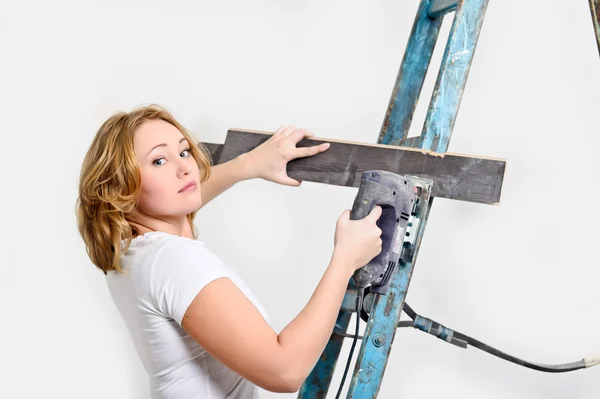 Girl with a jigsaw and board — Stock Photo, Image