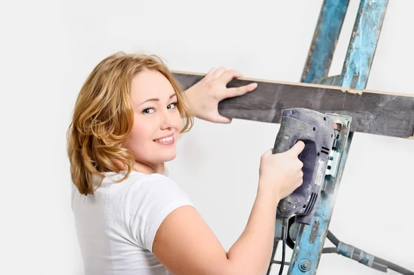 Girl with a jigsaw and board — Stock Photo, Image