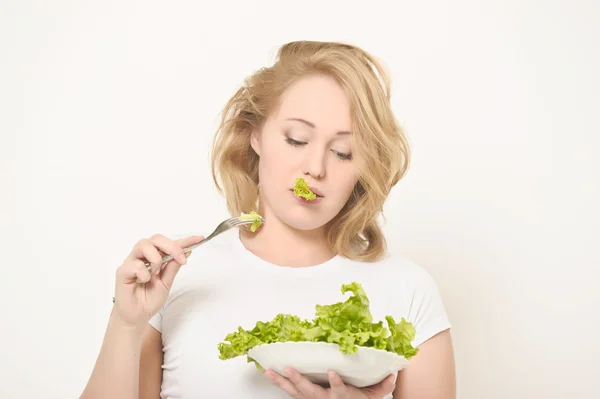 Menina e folhas de salada — Fotografia de Stock