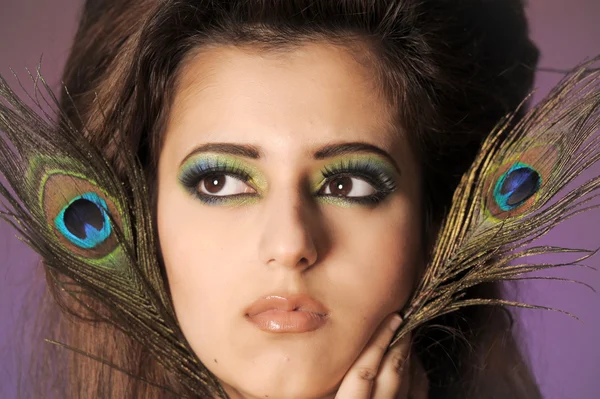 Portarit of beautiful young girl with peacock feather — Stock Photo, Image