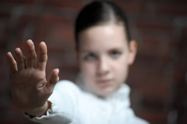 Teenage girl with hand up — Stock Photo, Image