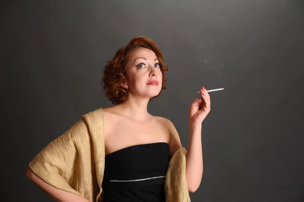 Woman smokes a cigarette Royalty Free Stock Images