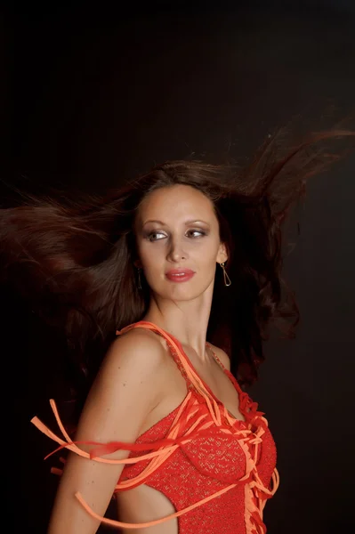 Beautiful dark-haired woman in a red dress — Stock Photo, Image