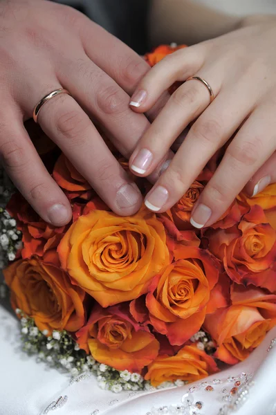 Wedding Bouquet with hands and rings — Stock Photo, Image