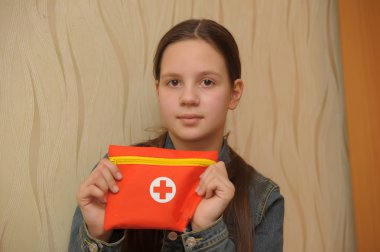 The girl the teenager holding first aid kit clipart