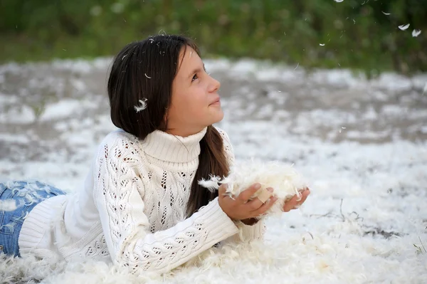 Young beautiful girl filled up by small feathers — Stock Photo, Image