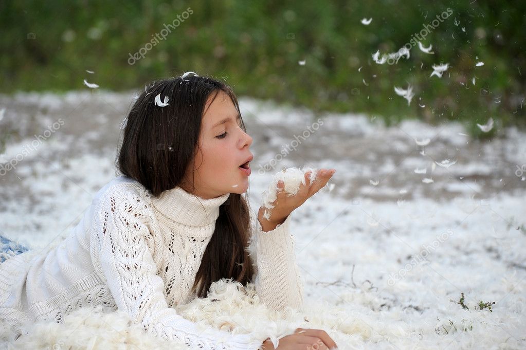 Young Beautiful Girl Filled Up By Small Feathers Stock Photo