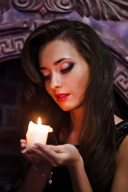 Portrait of a beautiful woman with a candle clipart