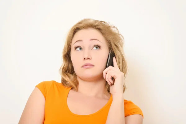 Girl speaks by a mobile phone — Stock Photo, Image