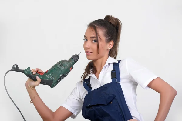 Closeup of a beauty girl with drill machine on white background — Stock Photo, Image