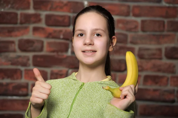 The girl the teenager with banana — Stock Photo, Image