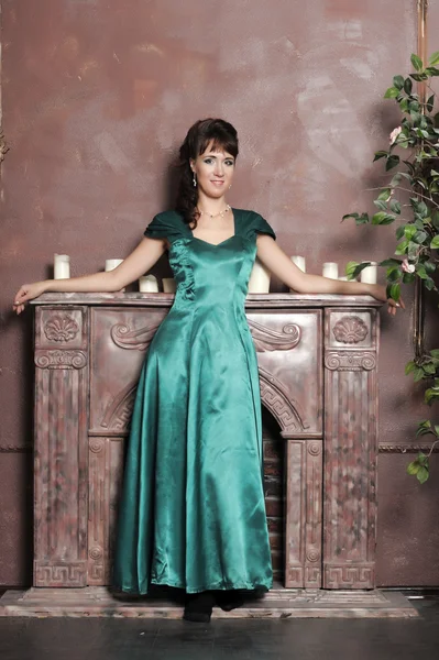 Young beautiful woman in an emerald dress — Stock Photo, Image