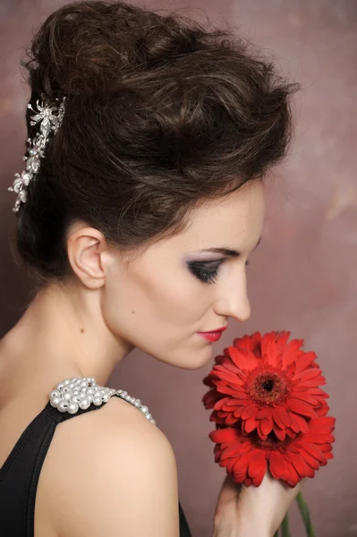 Attractive woman with red flowers Royalty Free Stock Photos
