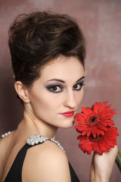 Attractive woman with red flowers Stock Picture
