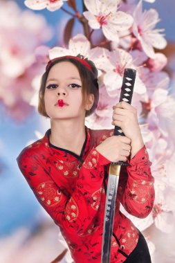 A girl handling a long samurai sword clipart