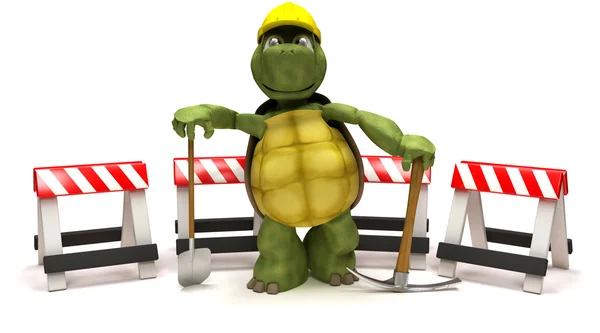 Tortoise with a spade and pick axe with hazard barriers — Stock Photo, Image