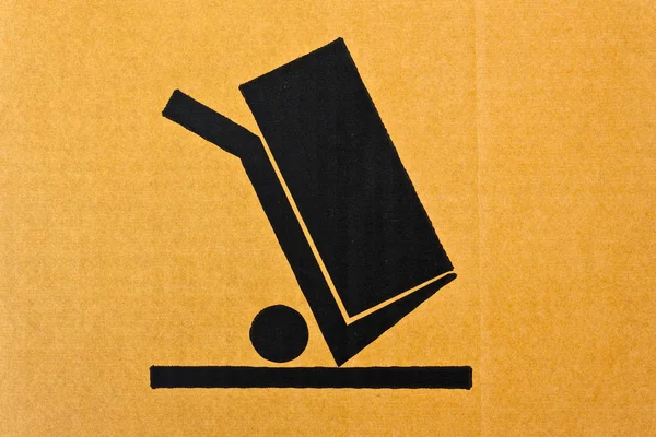 Bild närbild av grunge svart bräckliga symbol på kartong — Stockfoto