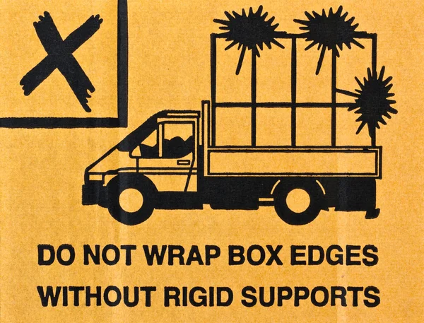 Image close-up of grunge black fragile symbol on cardboard — Stock Photo, Image
