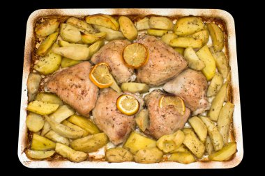 Roasted chicken thighs with potatoes and lemon.