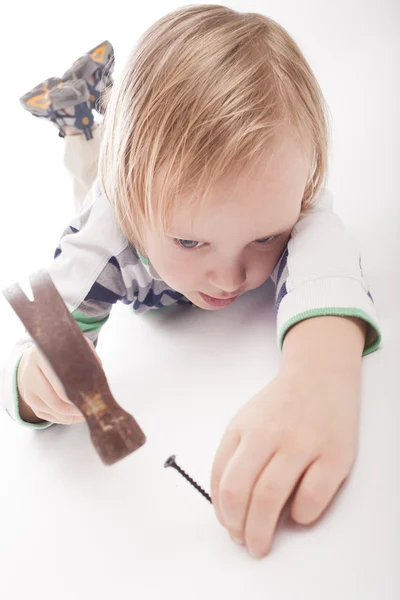 Boy with hammer and nail — Stock Photo, Image