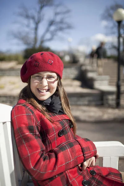 Positive school age girl is in the park — Stock Photo, Image