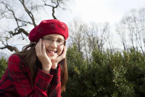 Positive school age girl is in the park — Stock Photo, Image