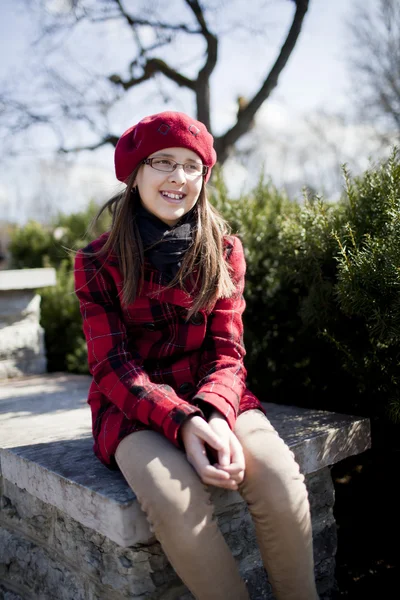 Positive school age girl is in the park Stock Picture