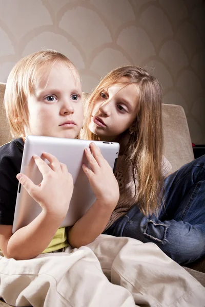 Девочка и мальчик с планшетным компьютером — стоковое фото