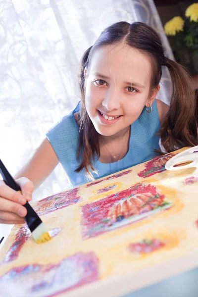 Positive schoold girl are painting at home — Stock Photo, Image