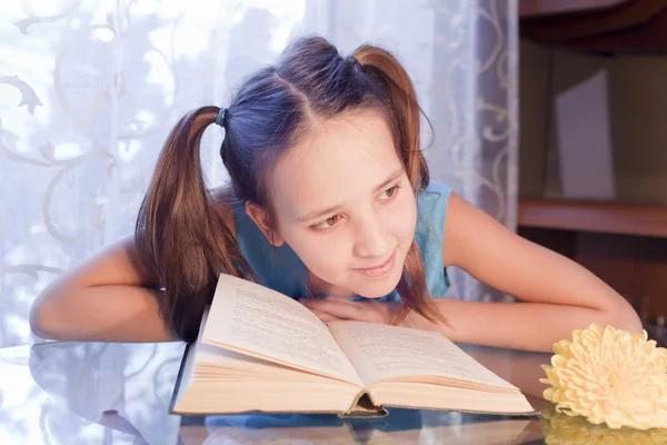 Smiling school girl is near the open book — Stock Photo, Image