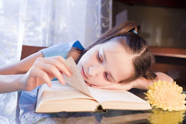 Positive schoold girl with book at home — Stock Photo, Image