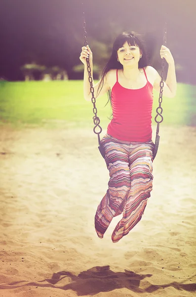 Young beautiful woman on swing — Stock Photo, Image