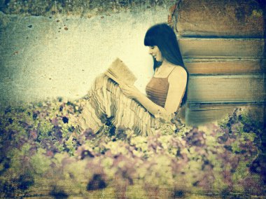 Woman reading book on the meadow clipart