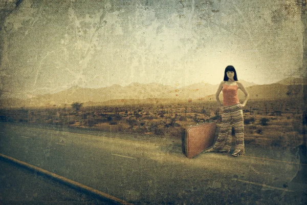 stock image Young woman with suitcase on the road