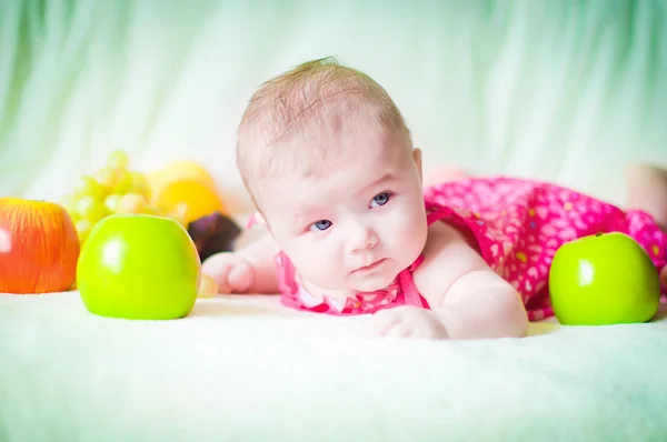 Baby with fruit — Stock Photo, Image