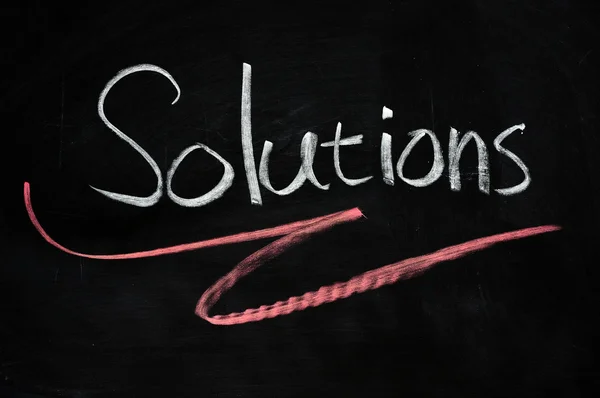 Solutions written on blackboard — Stock Photo, Image