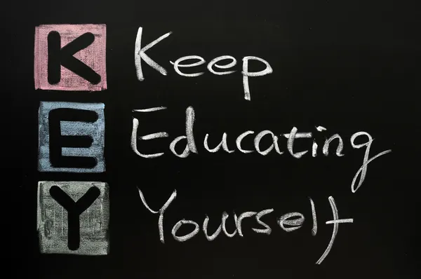 KEY acronym -Keep educating yourself on a blackboard with words written in — Stock Photo, Image