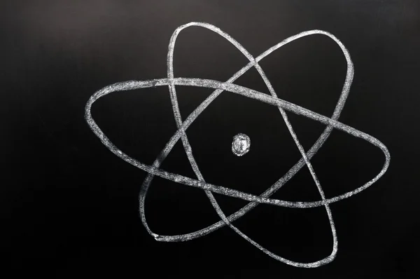 Symbol of atom sketched on a blackboard — Stock Photo, Image