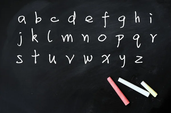 English alphabet handwritten with white chalk on a blackboard — Stock Photo, Image
