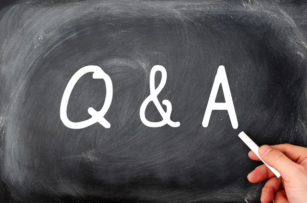 Question and Answer written on a blackboard with a hand holding chalk — Stock Photo, Image