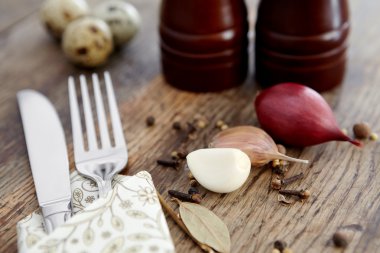 Spices, garlic and onions, fork and knife. clipart