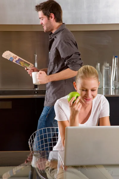 Couple at home woman using laptop — Stock Photo, Image