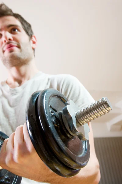 Man lifting dumbbell in gym — Stock Photo, Image