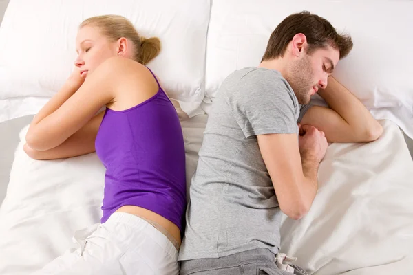 Couple lying in bed back-to-back — Stock Photo, Image