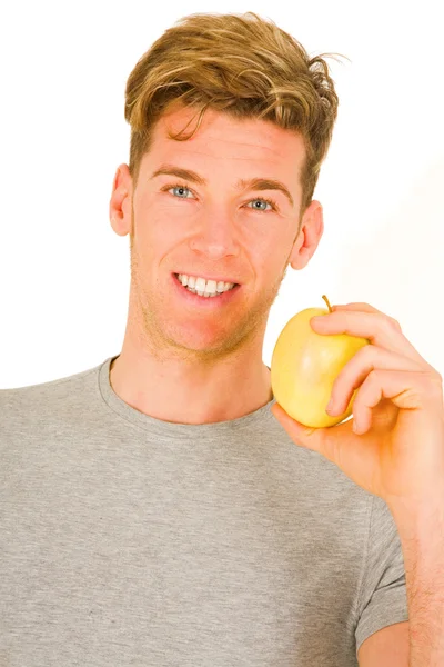 Young man holding an apple — Stock Photo, Image
