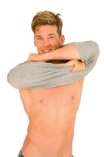 Young man takeing off the t-shirt — Stock Photo, Image
